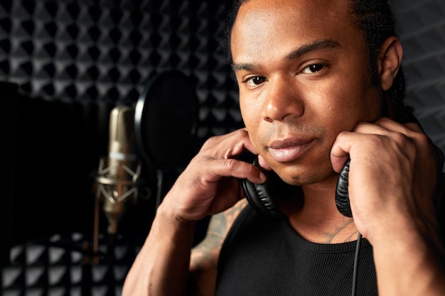 Professional singing lessons team instructor demonstrating vocal techniques for music students